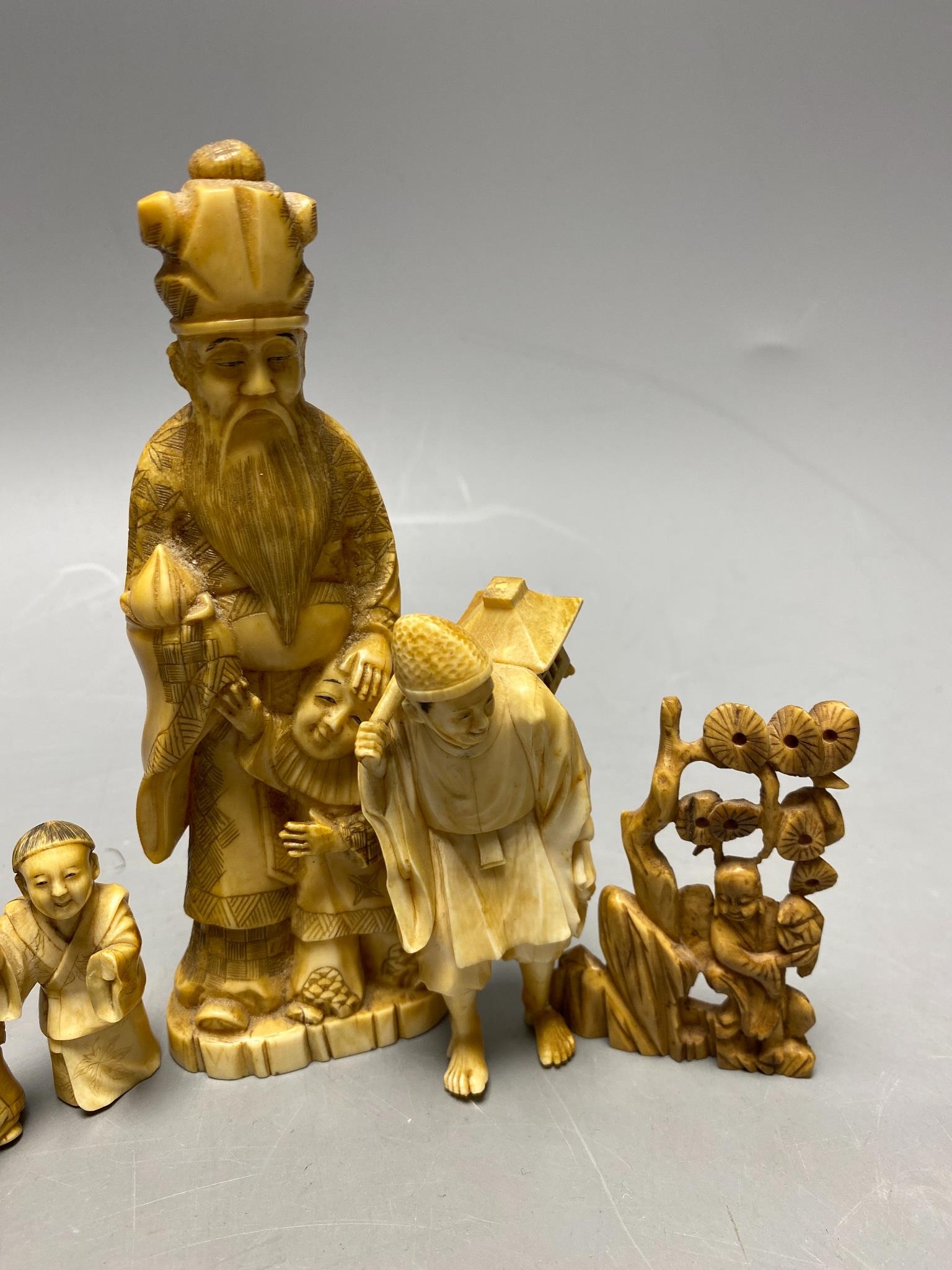 A Japanese walrus ivory group and an incomplete ivory okimono of group of Daikoku and a Chinese ivory carving (4)